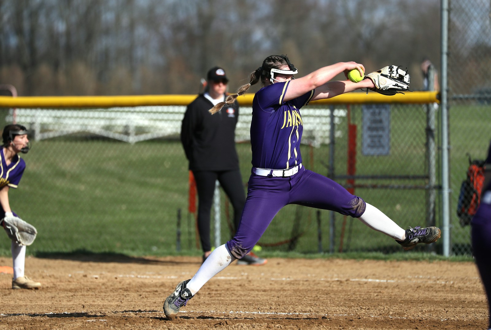 Softball pitcher delivering a pitch during a game